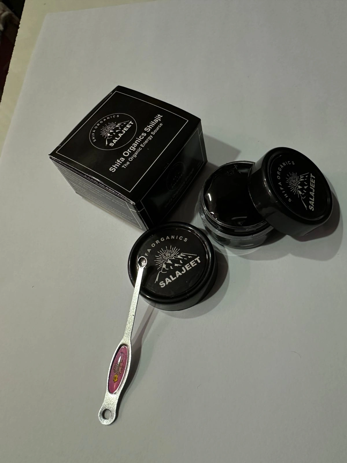 Authentic Himalayan shilajit resin oozing from mountain rocks with snow peaks in background | Mineral-rich Ayurvedic superfood